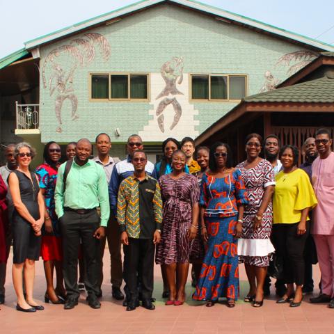 Members of the National Nutrition Partners Coordination Committee (NaNuPacc) taking a group photo in front of a building.
